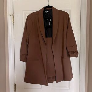 Two piece brown suit, tucked sleeves flare top bottoms are skinny fitted